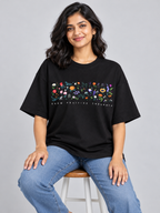 Black Grow Positive Thoughts Floral Printed Oversized T-Shirt — seated model view