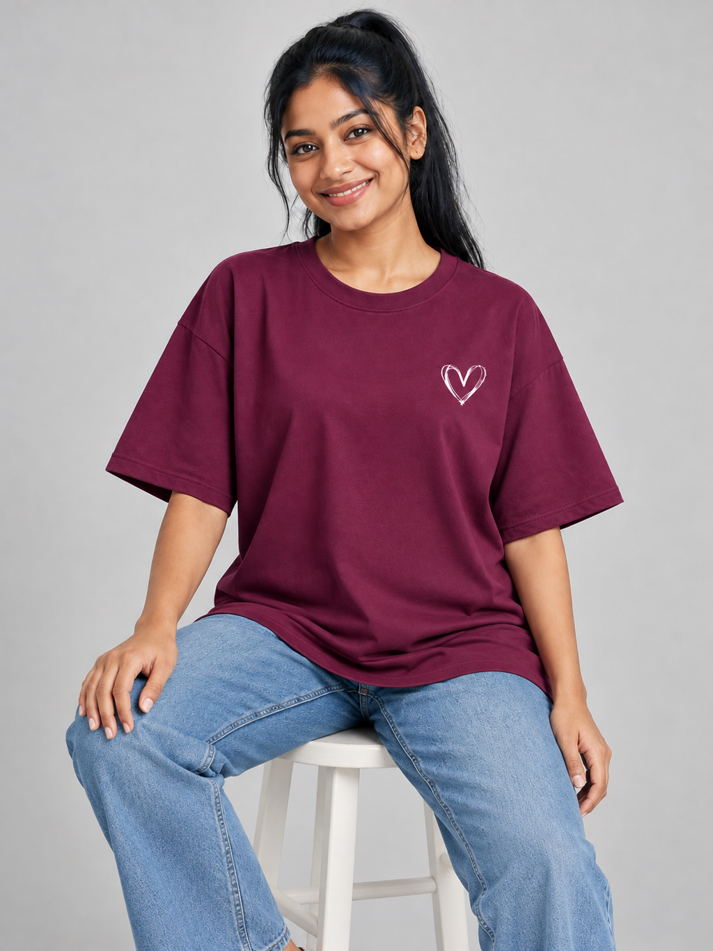 mini heart wine oversized T-shirt — seated model view #colour:wine